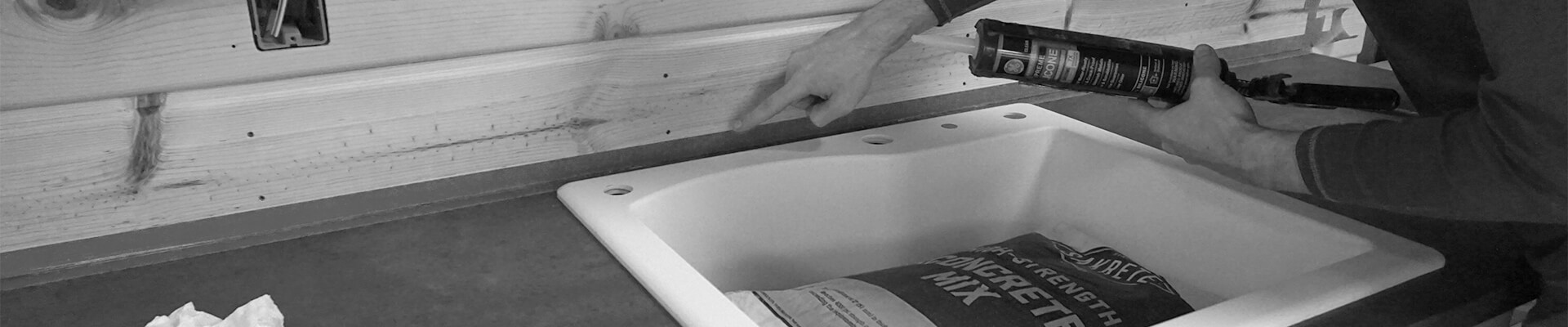 A close-up view of the kitchenette being built in the Mini Dome in black and white.
